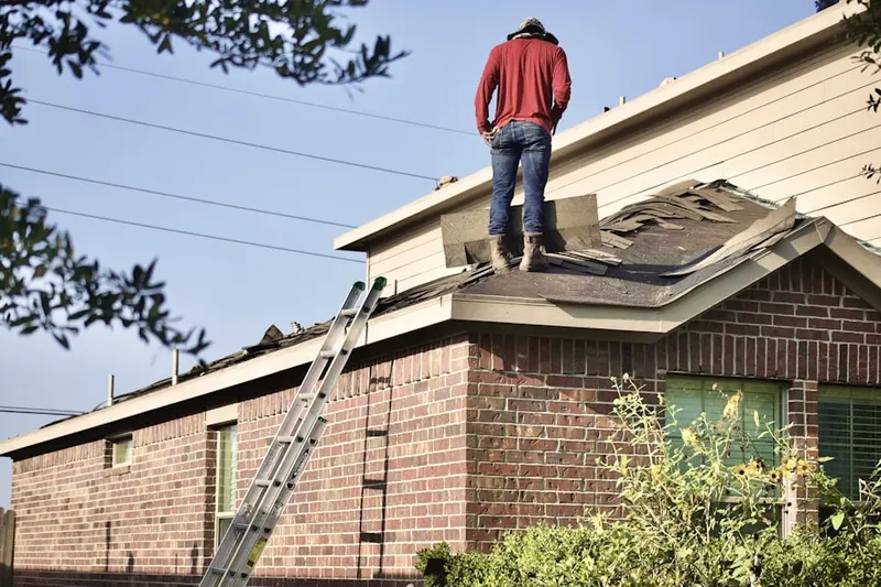 Professional roofer working on a residential roof in Bishop